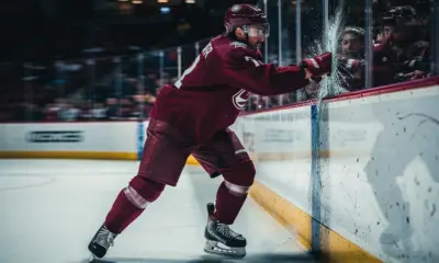 Boston Bruins players warming up on ice before a critical road game against the Pittsburgh Penguins