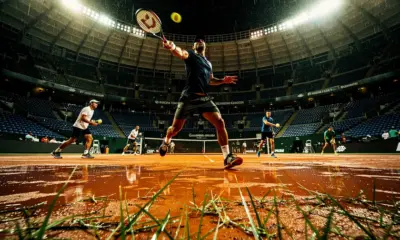 Carlos Alcaraz practicing on clay court with Real Madrid Bernabeu stadium in the background