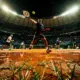 Carlos Alcaraz practicing on clay court with Real Madrid Bernabeu stadium in the background