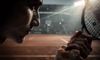 Carlos Alcaraz preparing to serve on red clay at the 2026 Monte-Carlo Masters tournament