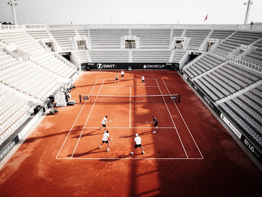 Players competing in Davis Cup Tennis Nations League tie on clay court in 2026