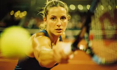 Jessica Pegula preparing to serve during a 2026 clay court tennis match in spring