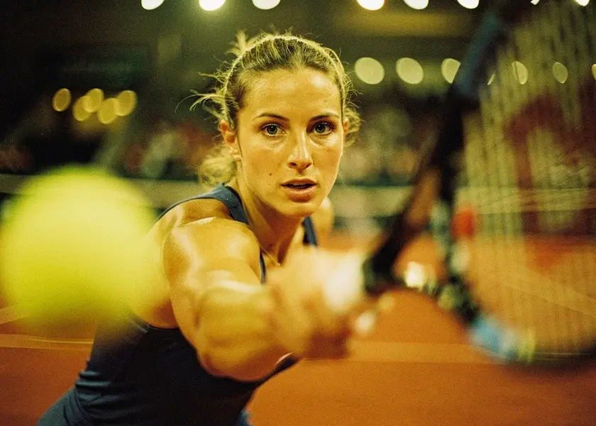Jessica Pegula preparing to serve during a 2026 clay court tennis match in spring